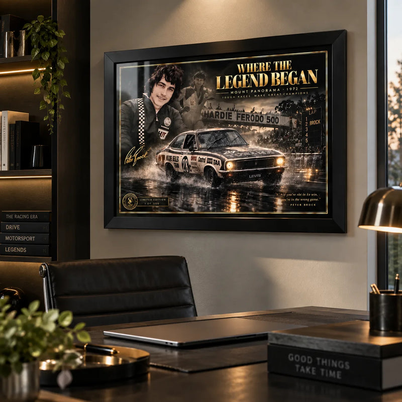 Peter Brock wall art displayed above a desk in a modern office, styled in a black frame for a motorsport collector space.