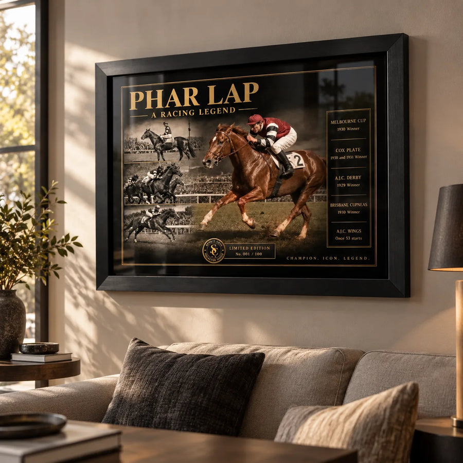 Black framed Phar Lap horse racing wall art displayed in a warm living room above a neutral sofa beside a floor lamp.