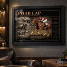 Black framed Phar Lap horse racing wall art displayed in a dark man cave with leather seating and warm ambient lighting.