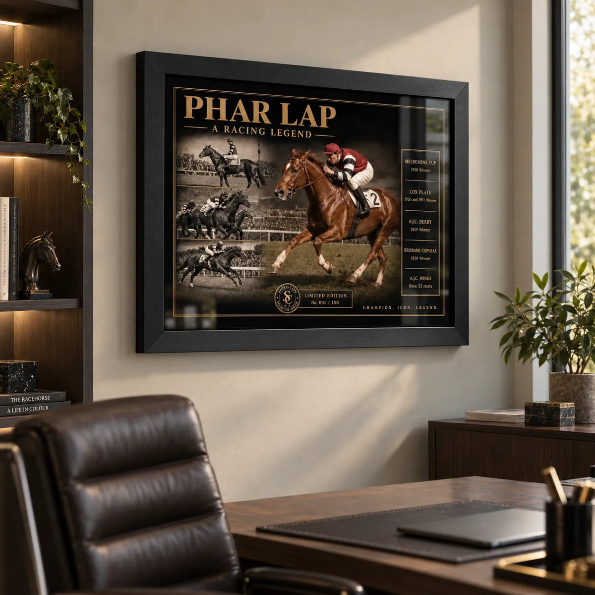 Black framed Phar Lap horse racing wall art displayed in a modern office above a wooden desk and leather chair.
