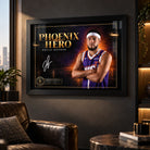 Devin Booker Phoenix Hero wall art displayed in a dark man cave setting with a black frame and warm ambient lighting.