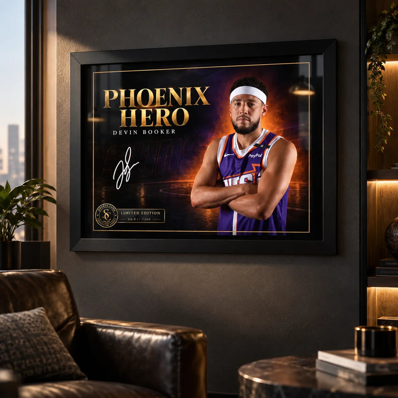 Devin Booker Phoenix Hero wall art displayed in a dark man cave setting with a black frame and warm ambient lighting.