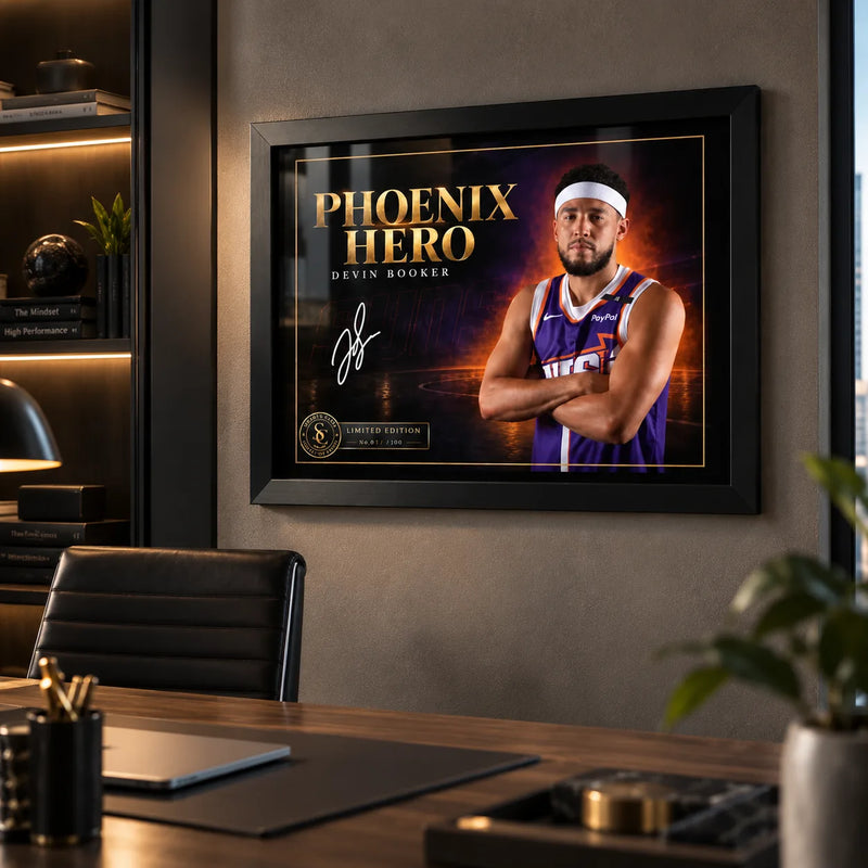 Devin Booker wall art displayed in a modern office setting, framed in black above a desk for a basketball fan workspace.