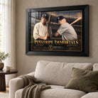 Black-framed Pinstripe Immortals artwork featuring Ruth and Mantle above a cream sofa in a sunlit living room.