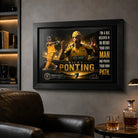 Ricky Ponting framed cricket wall art mounted in a masculine man cave with charcoal walls, leather seating and warm lighting.