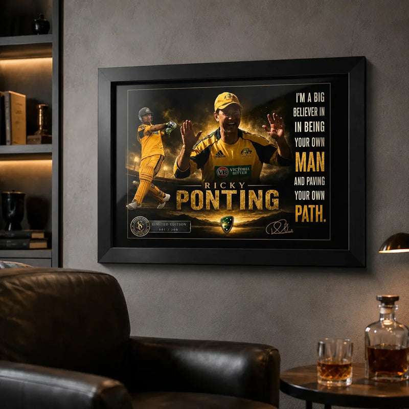 Ricky Ponting framed cricket wall art mounted in a masculine man cave with charcoal walls, leather seating and warm lighting.