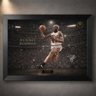 Dennis Rodman basketball wall art in a black frame showing an action artwork with arena background.