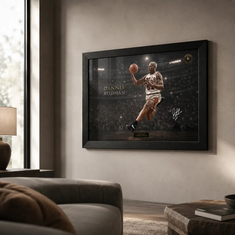 Dennis Rodman basketball wall art displayed in a black frame on a warm neutral living room wall.