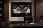 Executive office setting with framed sports memorabilia of Alex Rodriguez and Derek Jeter from The Divide rivalry.