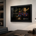 Black framed Ronaldinho soccer wall art displayed on a modern office wall above a dark desk.