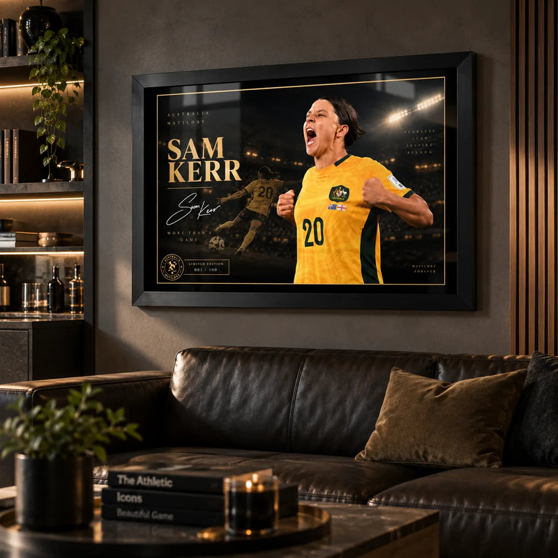Sam Kerr Matildas soccer wall art in a black frame displayed in a dark man cave above a leather sofa and bar shelving.