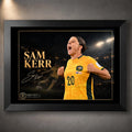 Black framed Sam Kerr Matildas soccer wall art featuring Kerr in Australia's yellow kit against a dark stadium background.