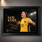 Black framed Sam Kerr Matildas soccer wall art featuring Kerr in Australia's yellow kit against a dark stadium background.