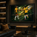 Black framed Sam Kerr and Mary Fowler Matildas soccer wall art displayed in a dark sports room with warm shelf lighting.