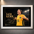 White framed Sam Kerr Matildas soccer wall art featuring Kerr in Australia's yellow kit with a dark stadium backdrop.