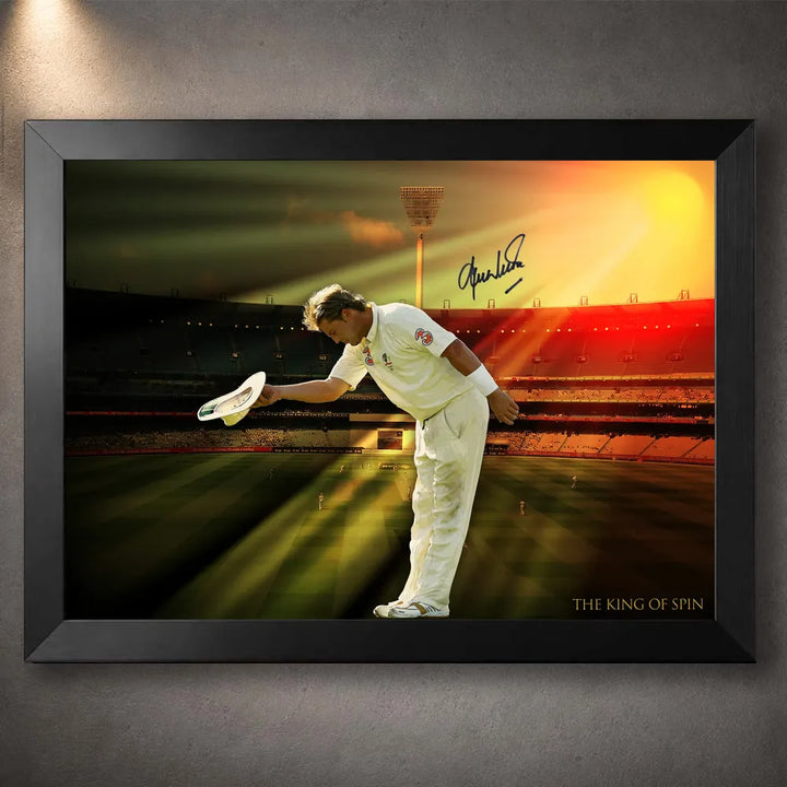 Black framed Shane Warne cricket wall art showing the King of Spin bowing beneath golden stadium light.