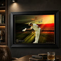 Black framed Shane Warne cricket wall art displayed on a charcoal man cave wall beside warm timber shelving.