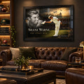 Shane Warne The Final Bow black framed cricket edition displayed above a leather sofa in a dark sports collector man cave.