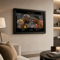 Shaq vs Hakeem framed basketball wall art displayed on a warm living room wall with black frame and glass