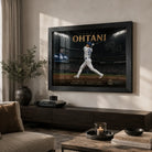 Framed Shohei Ohtani baseball wall art displayed above a dark timber console in a softly lit modern living room.