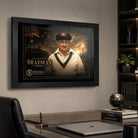 Sir Donald Bradman framed cricket wall art displayed above a refined office desk in a masculine study.