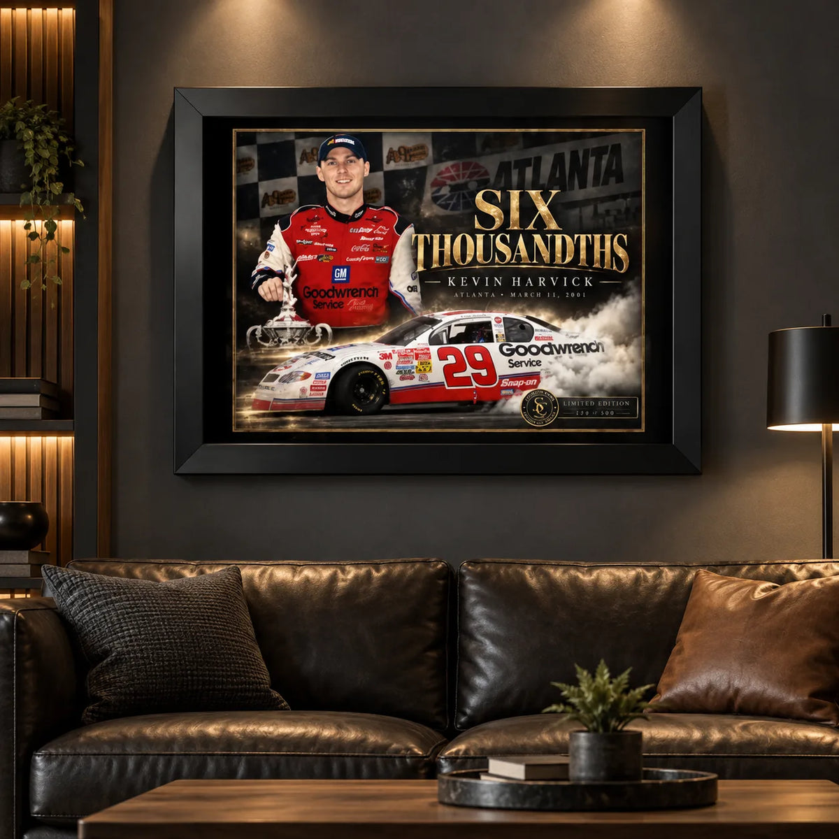 Kevin Harvick Six Thousandths wall art displayed in a dark motorsport man cave above a leather sofa.