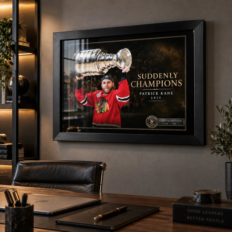 Patrick Kane hockey wall art in a modern office, shown in a black frame above a desk with warm built-in lighting.