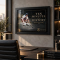 Black framed Ten Minutes To History hockey wall art displayed above a desk in a modern office setting.