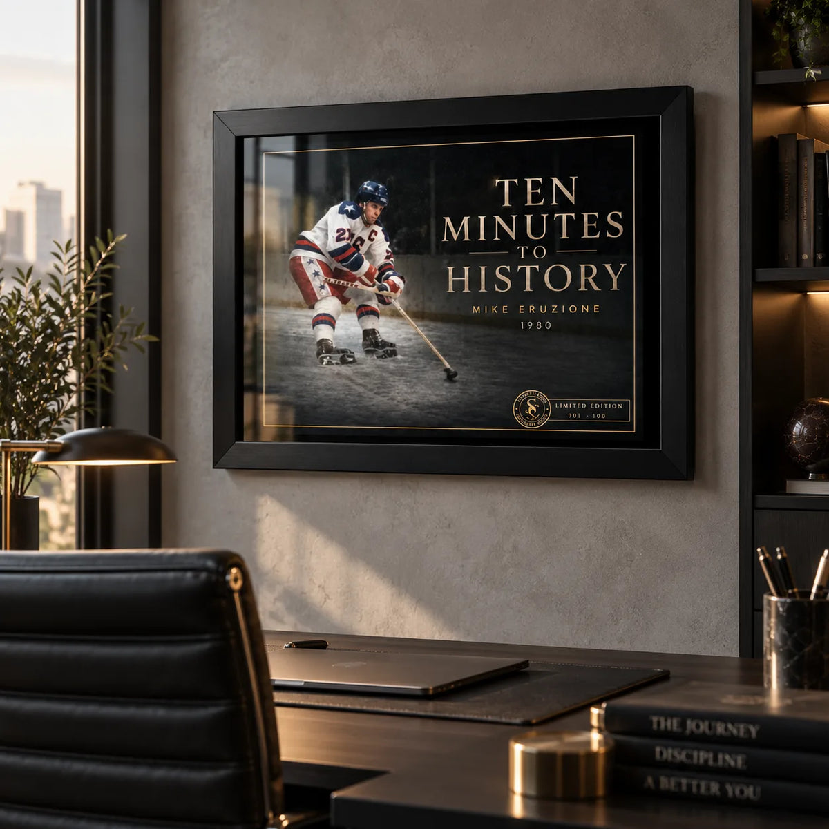 Black framed Ten Minutes To History hockey wall art displayed above a desk in a modern office setting.