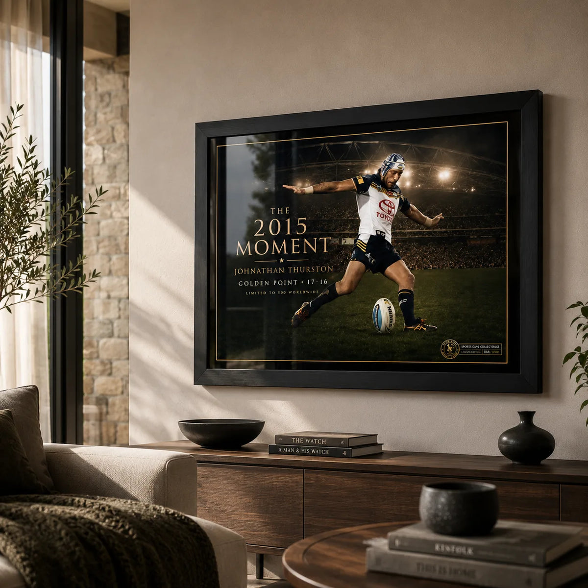 Jonathan Thurston wall art in a contemporary living room, with the black frame and stadium scene displayed above timber furniture.