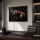 The Attitude Stone Cold vs The Rock framed wall art displayed on a light wall in a modern executive office setting.