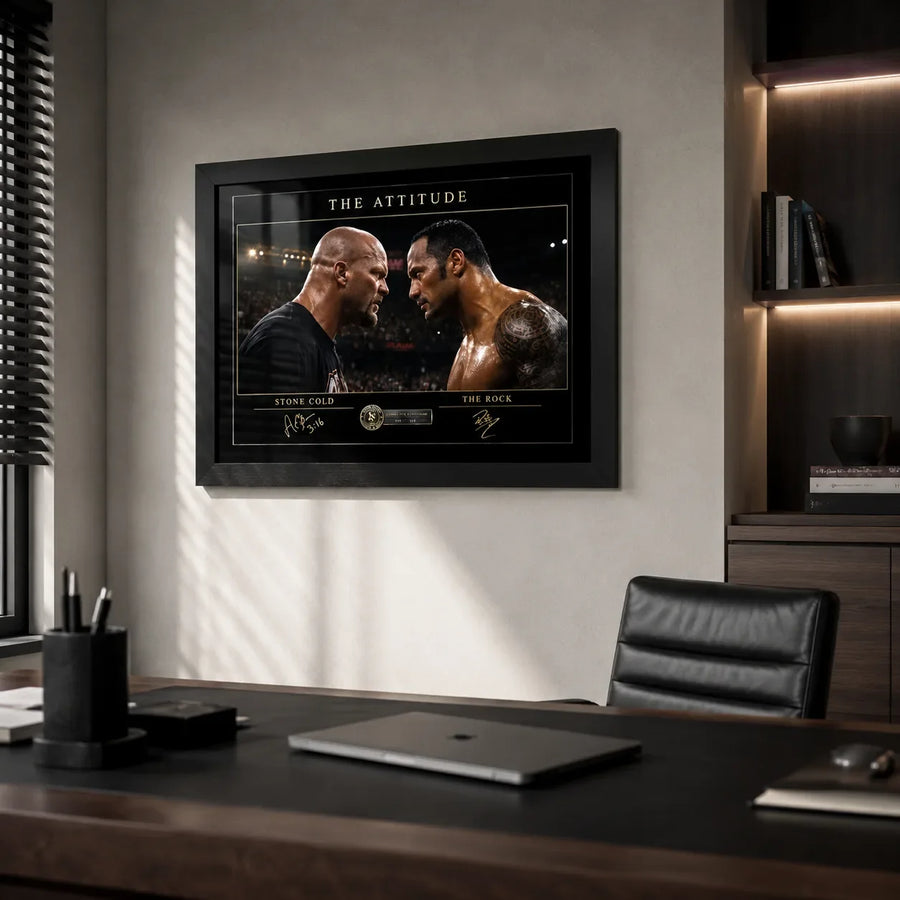 The Attitude Stone Cold vs The Rock framed wall art displayed on a light wall in a modern executive office setting.