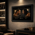 The Betrayal Shawn Michaels vs Bret Hart wall art displayed in a dark man cave beside a leather chair and drinks shelves.
