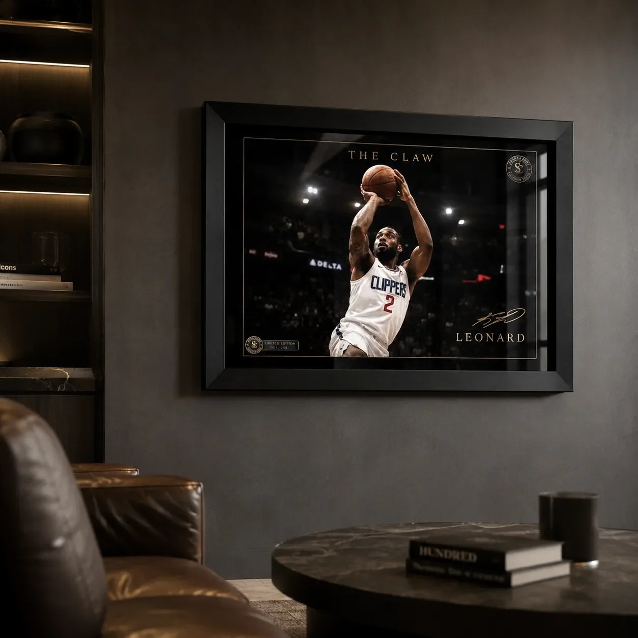 Kawhi Leonard The Claw basketball wall art in a black frame, displayed in a dark man cave with leather seating.