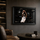 Kawhi Leonard The Claw basketball wall art in a black frame, displayed in a dark man cave with leather seating.