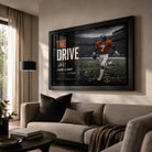 John Elway wall art displayed in a modern living room, showing The Drive collector piece in a black frame above a sofa.
