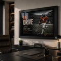 John Elway wall art displayed in a premium office, featuring The Drive in a black frame above a dark desk.