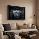 Aikman and Smith wall art in a warm neutral living room above a cream sofa, displayed in a premium black frame.