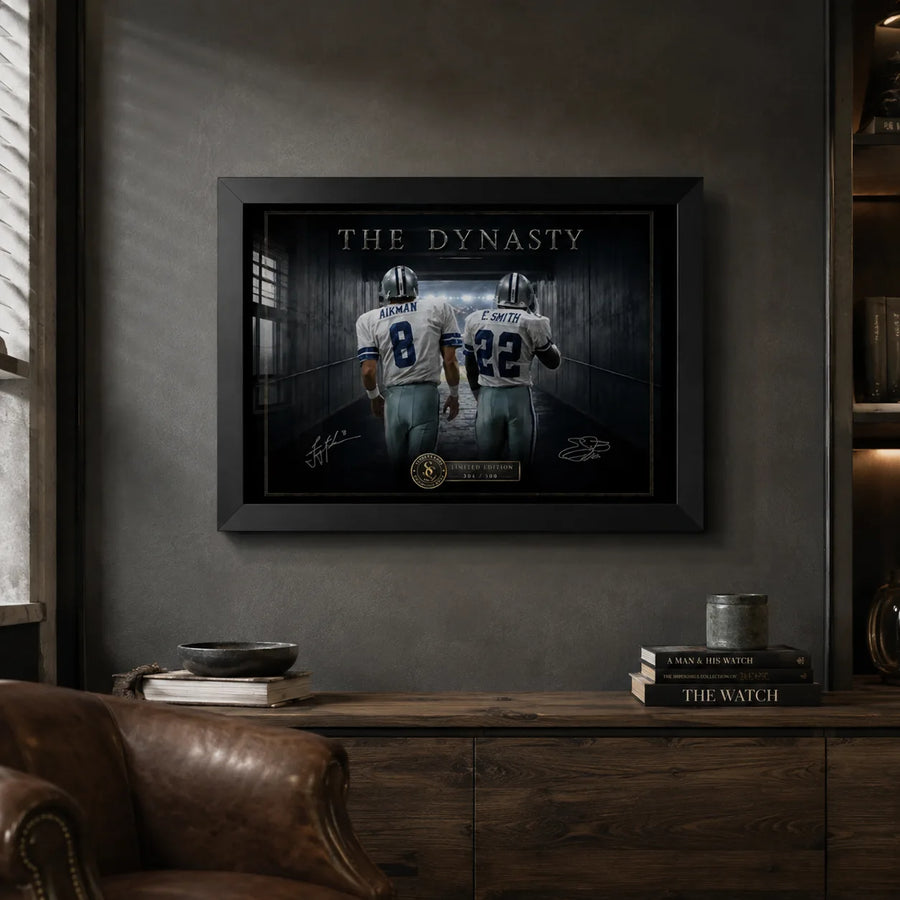Black framed Aikman and Smith wall art displayed in a dark man cave with timber cabinetry and a leather chair.
