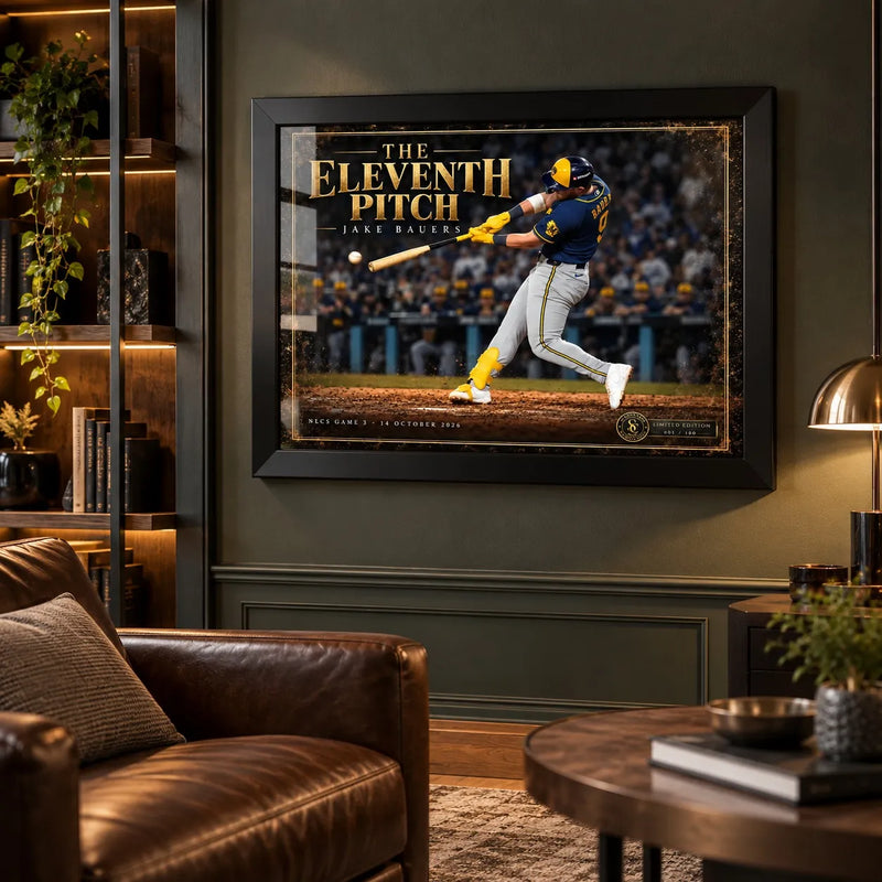 Jake Bauers wall art in a black frame displayed in a dark man cave with leather seating and illuminated shelves.