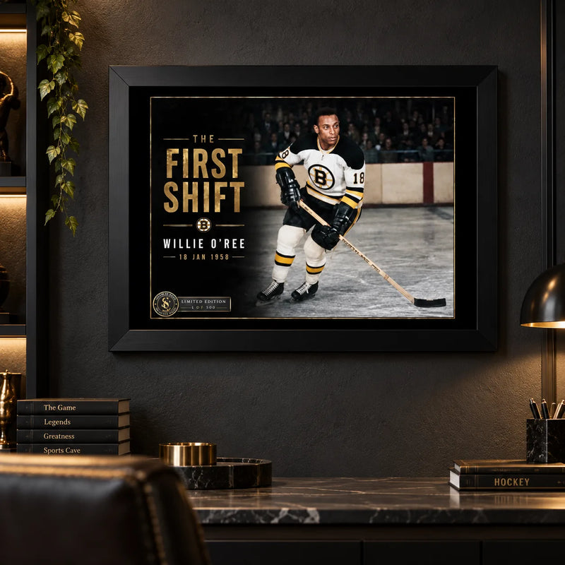 Willie O'Ree wall art displayed in a dark man cave setting with black frame, styled for serious hockey collectors.