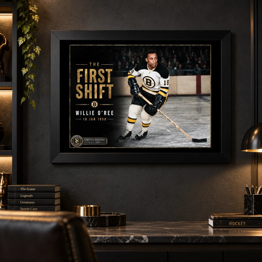 Willie O'Ree wall art displayed in a dark man cave setting with black frame, styled for serious hockey collectors.