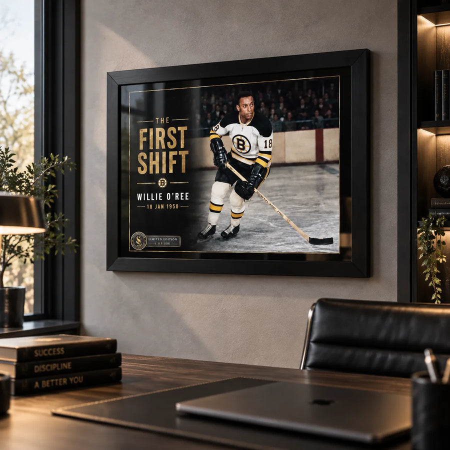 Black framed Willie O'Ree wall art displayed in a modern office, bringing hockey collector character to a professional space.