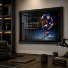 Matthew Schaefer hockey wall art displayed in a modern home office with dark shelving, desk and focused collector styling.