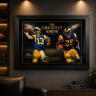 The Greatest Show NFL wall art displayed in a dark man cave setting with Kurt Warner and Marshall Faulk artwork framed in black.