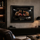 Tyson vs Ali boxing wall art mounted in a refined man cave with leather seating and illuminated shelving.
