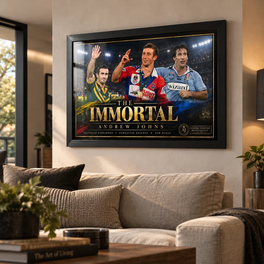 Black framed Andrew Johns rugby league wall art displayed above a sofa in a warm modern living room.