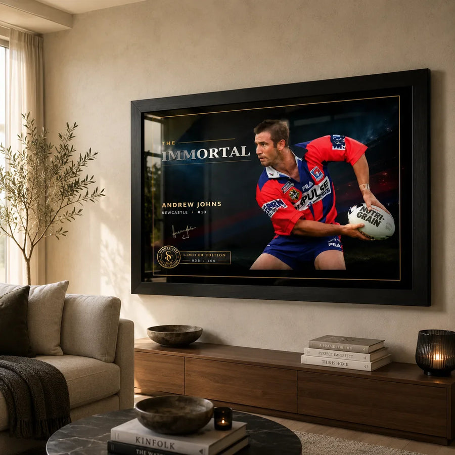 Andrew Johns wall art displayed in a warm living room, with the black framed The Immortal rugby league artwork above a timber console.