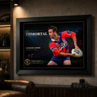 Andrew Johns wall art displayed in a dark man cave setting with the black framed The Immortal rugby league artwork as the focal point.