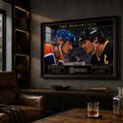 The Immortals Gretzky and Lemieux framed hockey artwork displayed in a dark premium man cave with leather seating.